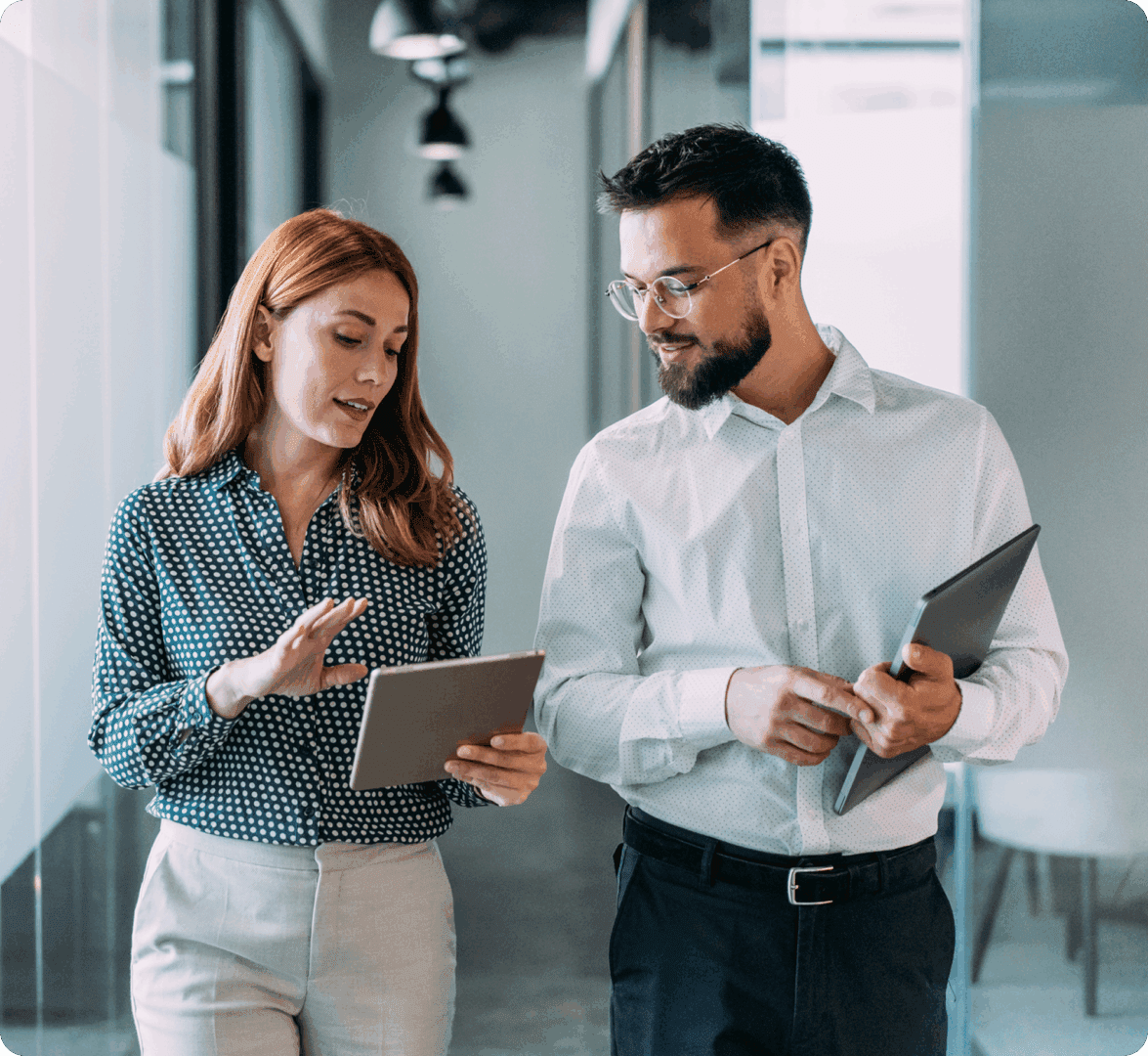 Professionals collaborating in modern office hallway