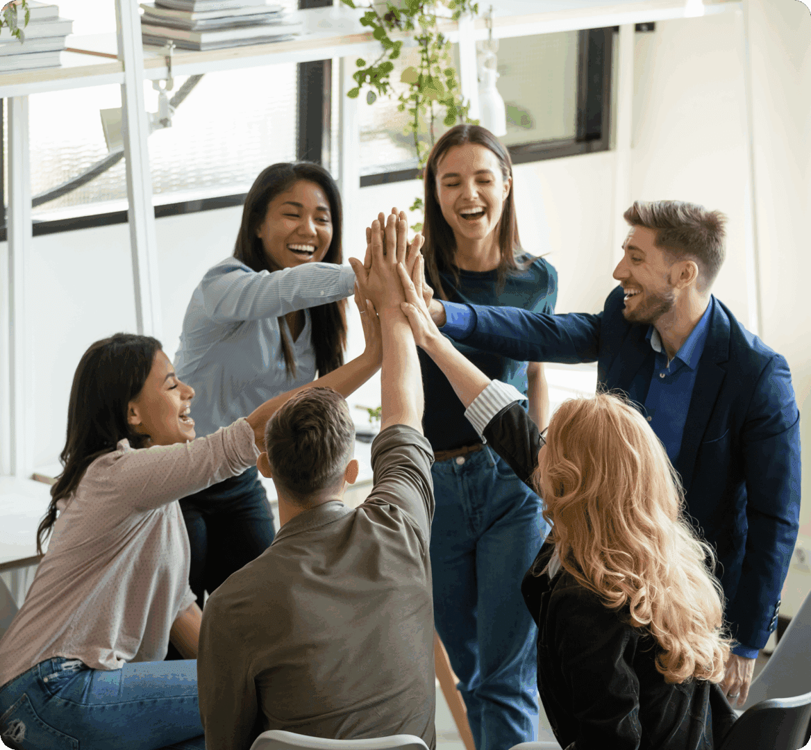Diverse team high-fiving in office